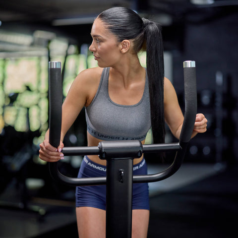 Woman exercising on a glute slide machine